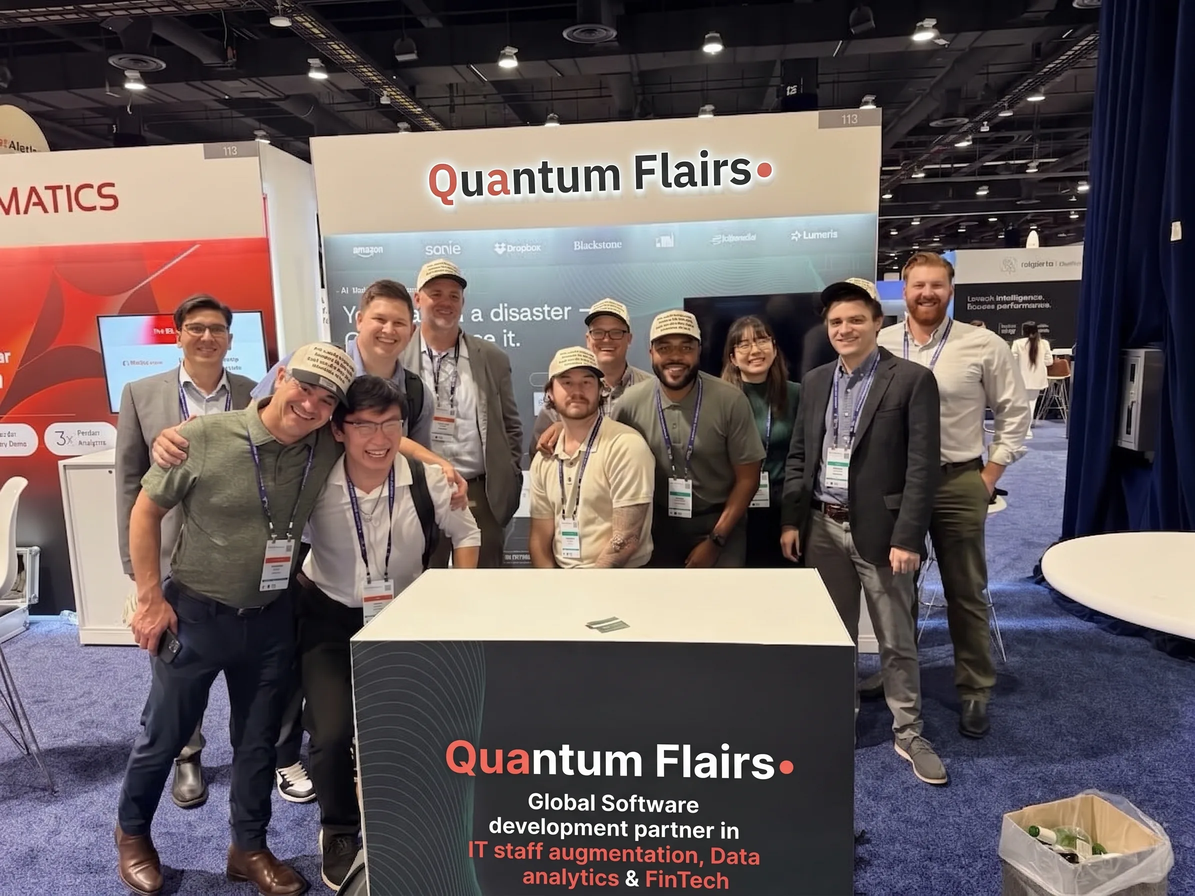 Quantum Flairs team and conference guests gathered at a booth